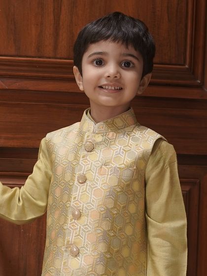 A close-up of the golden-beige Bundi set, highlighting the subtle texture of the fabric and the classic design.