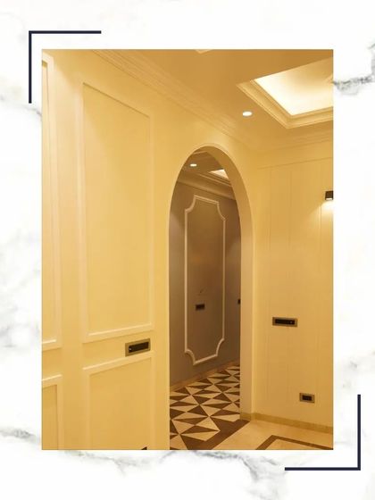 An arched doorway with classic moulding creates a graceful and elegant transition between spaces, adding architectural interest to the interior.