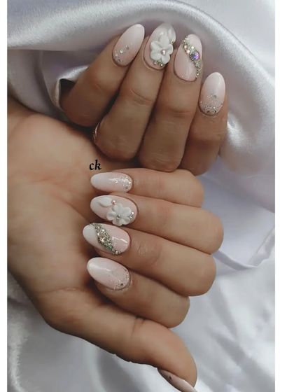 A beautiful nude bridal set with delicate glitter, 3D flowers, and intricate stone placement.