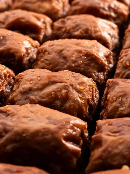 A rich, dark chocolate baklava. The lighting here is used to highlight the deep color and moist texture, differentiating it from the others.