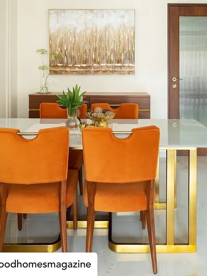 The dining room from our 'Calm Abode' project, featured in Good Homes Magazine. We used bold, burnt-orange velvet chairs to add a pop of color and warmth, contrasting beautifully with the white marble table and brass accents.