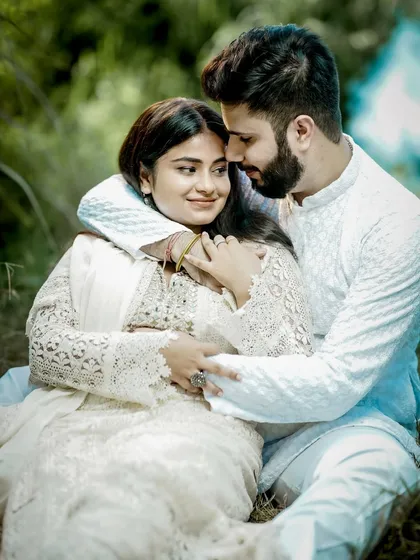 A playful and loving embrace. This candid moment from a pre-wedding shoot shows the couple's genuine chemistry and happiness.