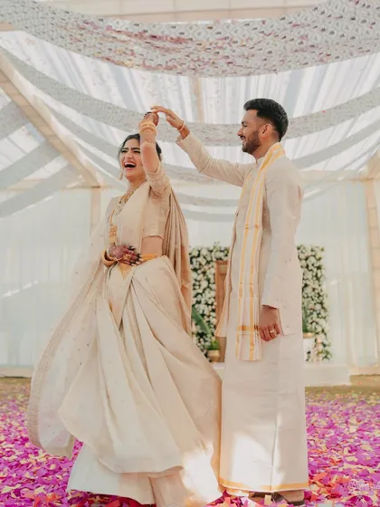 A playful dance during the South Indian Haldi. The simple elegance of the decor and attire allows the couple's joyful connection to be the main focus.