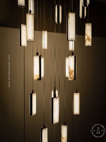 A detailed view of our leather and marble chandelier, highlighting the unique texture and warm glow of the illuminated marble panels. This fixture is a testament to our commitment to using premium materials.