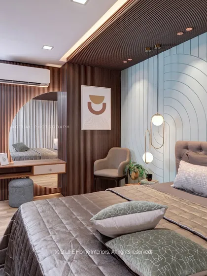 A full view of the bedroom in Madurai, showing the integrated dressing table with a semi-circular mirror that complements the room's geometric and textural wall designs.