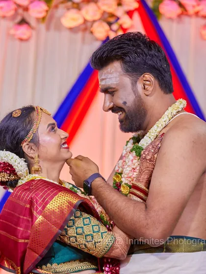 I love capturing the unique cultural details of every wedding. This candid shot from a South Indian wedding shows the couple sharing a happy, playful moment.