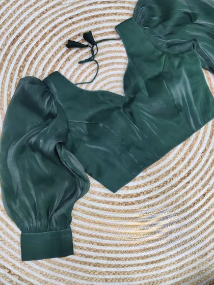 The organza blouse in a deep forest green.