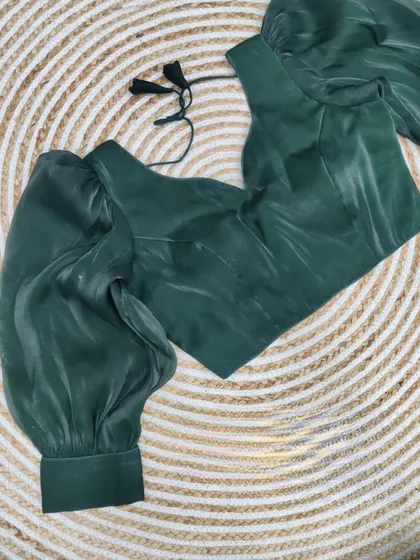 The organza blouse in a deep forest green.