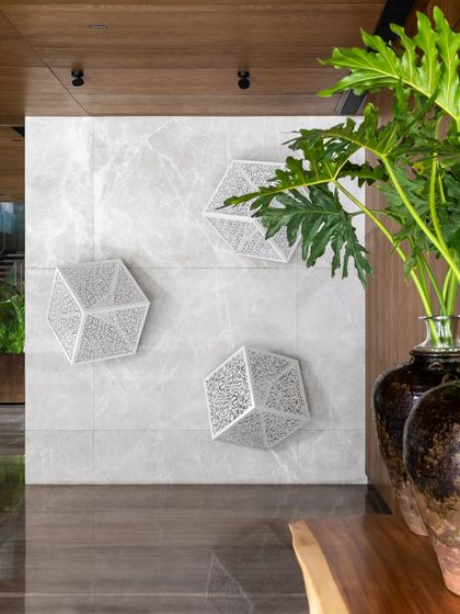 An art installation by Anila Quayyum Agha, featuring laser-cut steel cubes, mounted on a leather-finished Italian marble wall in the K Residence lobby. This highlights our approach of integrating significant art pieces into the architectural fabric.