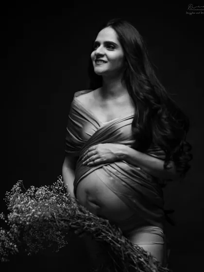 A beautiful combination of my fabric draping and a floral prop. This black and white portrait is both artistic and deeply personal, highlighting the bare bump.