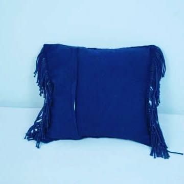 The back of our macrame cushion cover, showing the simple envelope closure. This is a 100% handmade piece in a deep blue color.