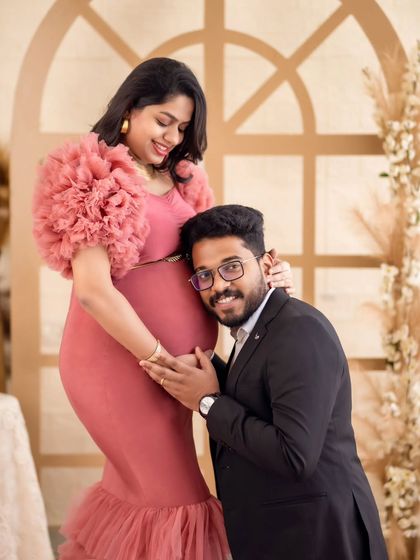 A sweet moment captured as the dad-to-be listens to the baby's heartbeat, surrounded by our warm boho studio decor.