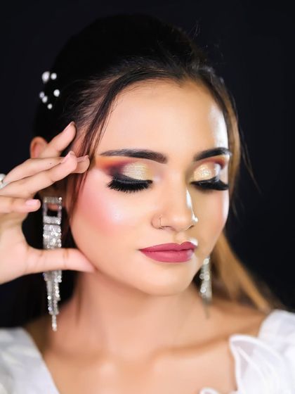 A detailed shot of the eye makeup, showing the beautiful blend of orange and gold eyeshadow.