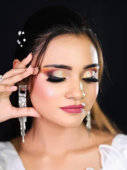 A detailed shot of the eye makeup, showing the beautiful blend of orange and gold eyeshadow.