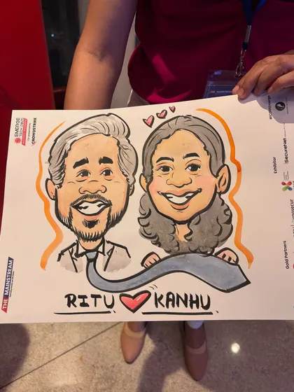 A close-up of a couple's caricature from a corporate event, featuring a creative twist with the tie connecting them. The event branding is included at the bottom.