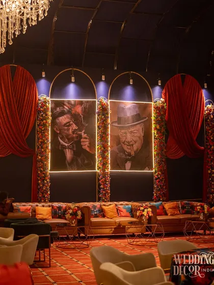 A cigar lounge corner I designed for the event, featuring classic leather sofas and portraits of famous cigar aficionados. This added another layer of thematic experience for the guests.