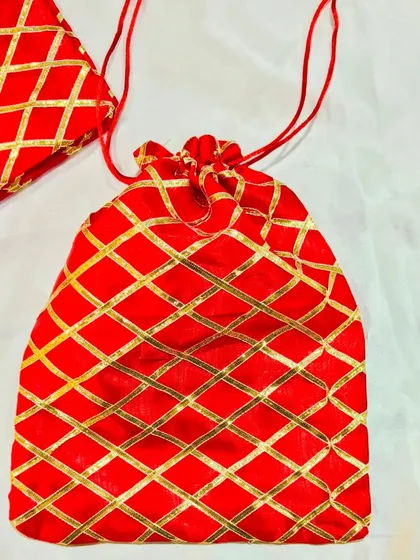 Our red potli bag with a gold lattice pattern is a classic and festive option for Diwali or wedding favors.