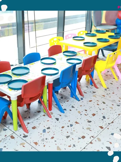 Our colorful, kid-sized tables are all set for mealtime. These tables are designed to be the perfect height for children, making it easy and fun for them to enjoy their food after a session of play.