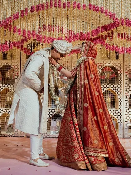 A quiet, intimate moment shared between the couple against the backdrop of an intricate floral mandap. Even in the most lavish settings, I strive to create space for personal connection.