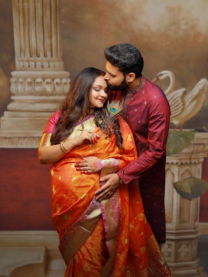 A tender kiss on the forehead, a classic expression of love and protection. This couple's pose is perfect for capturing the emotional bond during pregnancy.