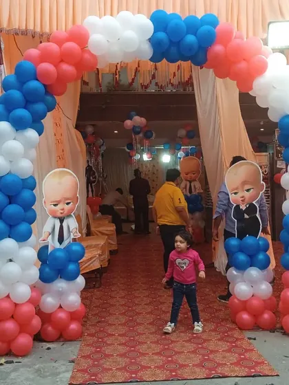 A grand entrance arch for a Boss Baby themed party. I used red, white, and blue balloons to create the arch, with Boss Baby character cutouts on the pillars to welcome guests.