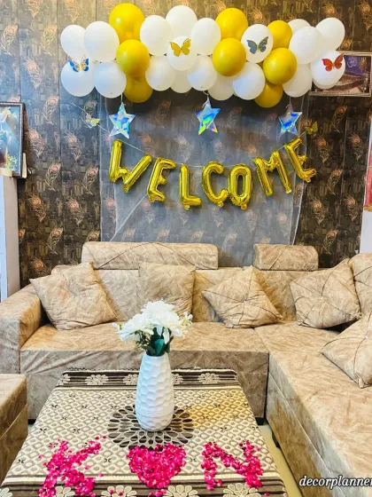 A bright and cheerful welcome decoration I did for my friends. The yellow and white balloons, 'Welcome' foil banner, and flower petal initials on the table made their homecoming extra special.