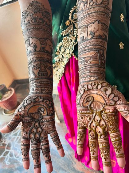 It's an honour when clients return for their bridal mehendi after I've done their engagement design. This piece features beautiful peacocks and the couple's names.