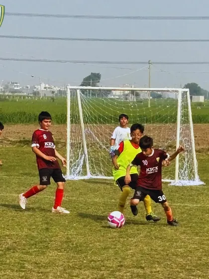 A tense moment in front of the goal as our players defend against an attack. We train our teams to be solid and organized in defense.