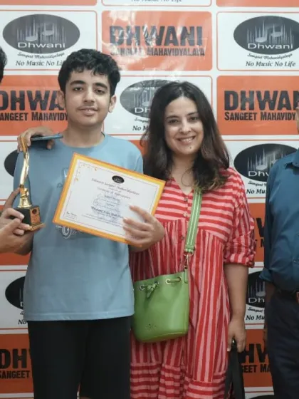 A student with his family and teachers, celebrating his award.