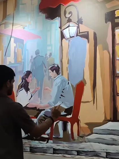 The mural progresses further, with the central figures of the couple at the cafe table taking shape. Each layer of paint adds more definition and narrative detail to the romantic street scene.