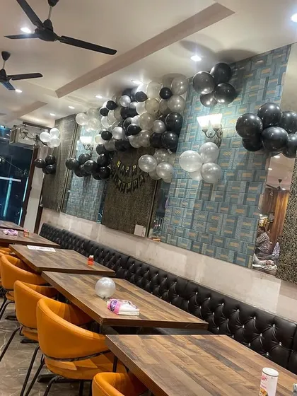 Another view of the restaurant, showing how the balloon clusters are placed along the wall to add a festive touch without taking up too much space.