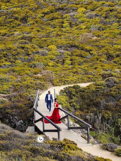 This red trail gown traveled all the way to the US for this gorgeous shoot. The color stands out so beautifully against the lush, green landscape of the American coastline.