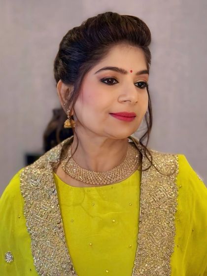 A close-up portrait showcasing the client's glowing makeup and elegant hairstyle. The look is polished and perfect for any special occasion.