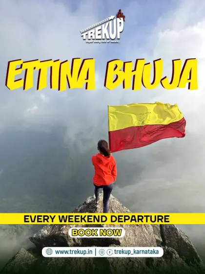 A trekker stands proudly at the summit of Ettina Bhuja, holding the Kannada flag. This peak offers a true sense of accomplishment and connection to our beautiful state.