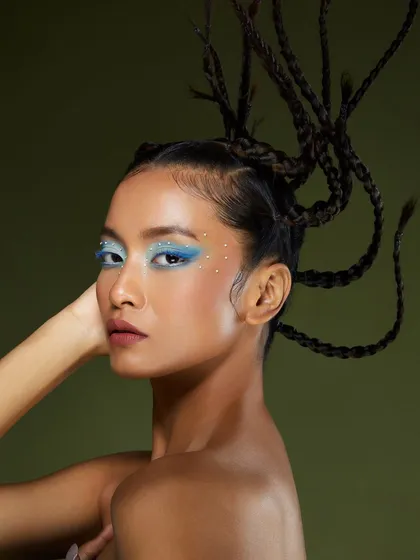 A beautiful, icy blue eyeshadow look with delicate rhinestone accents, created by a student at our Delhi academy. The braided hairstyle adds a modern, edgy touch.