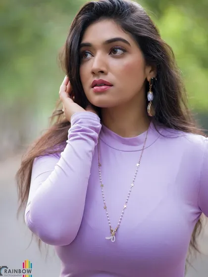 A pensive side-profile of Priyanka Thimmesh, highlighting her features and the simple elegance of her outfit.