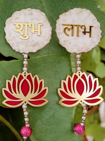 Welcome positivity into your home with these stunning Shubh Labh hangings. I designed these with a clean white resin base and a vibrant red lotus motif to look beautiful on any door or wall.