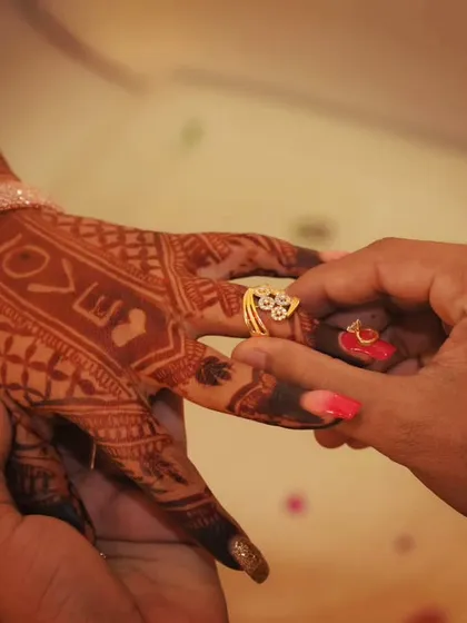 A beautiful moment captured during an engagement, where the henna design includes the word "LOVE" as a personal touch.