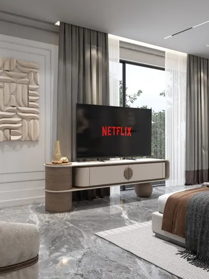 The TV and console area in this bedroom are designed with clean lines and sculptural art. The large window with heavy drapes allows for control over natural light, ensuring a comfortable environment.