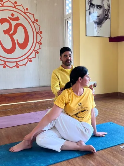 We believe in proper alignment to ensure a safe and effective practice. Our instructors provide personal, hands-on adjustments, helping you deepen your understanding of each asana, like this Ardha Matsyendrasana (Half Spinal Twist).