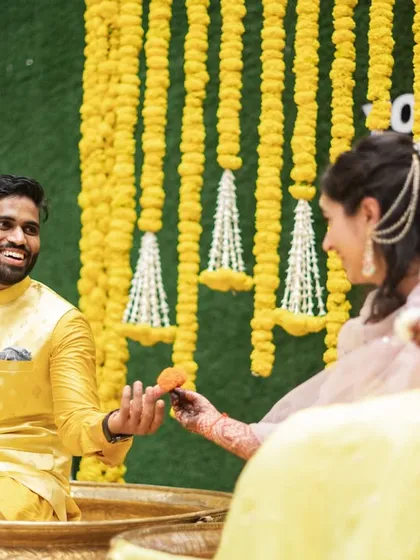 A sweet, candid moment between the bride and groom during their haldi ceremony.