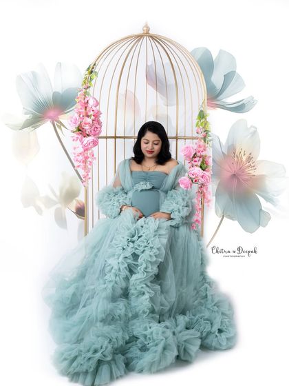 A dreamy and artistic composition. This mom-to-be in a flowing blue gown looks like she's part of a beautiful painting.