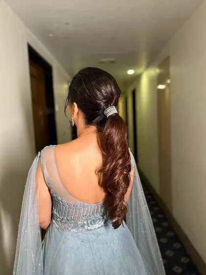 This angle shows the sleekness of the ponytail and the beautiful flow of the curled ends.