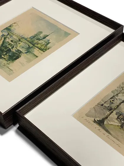 A detail shot of two framed prints, showing the clean, mitered corners of our metal frames. The consistent style creates a cohesive look when displaying multiple pieces together.