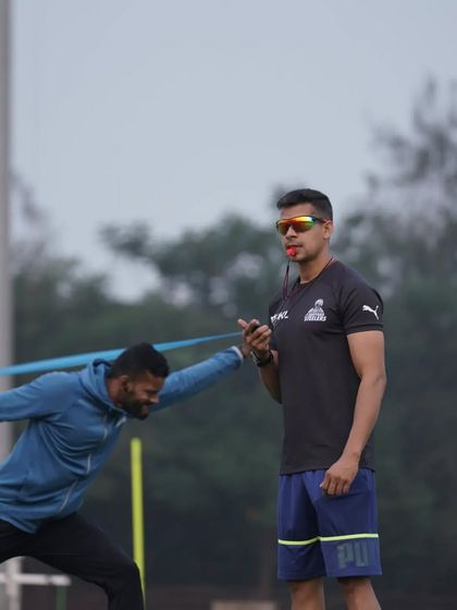 The athlete's expression shows the intensity of the drill. Pushing against resistance builds the raw power needed to accelerate and decelerate on the field.