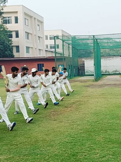 Group shadow batting drills led by a coach. This helps the entire squad practice their form, balance, and shot execution in unison.