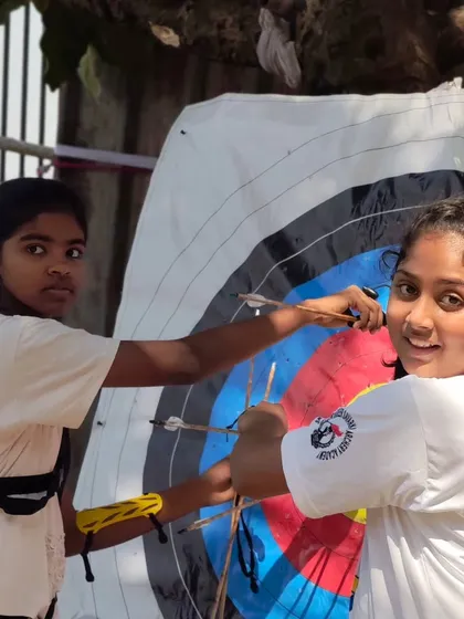 Two young archers smiling as they retrieve their arrows. Competition can be fun too.