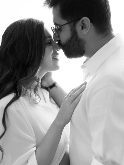 A soft and intimate black and white close-up. The gentle nose-to-nose touch and her happy smile make this a truly heartwarming portrait celebrating their journey.