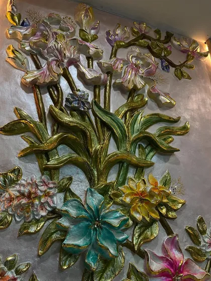 The upper section of the floral mural, where the flowers seem to reach towards the ceiling.