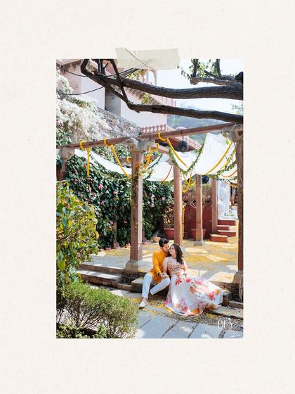 A romantic, framed shot of the couple sharing a quiet moment amidst the Haldi celebrations at Fort Neemrana.